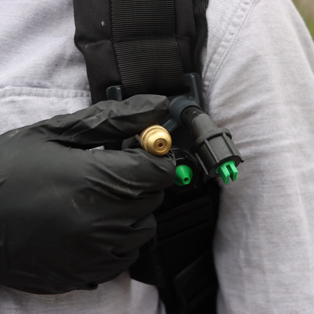 hand reaching for a nozzle in nozzle holster